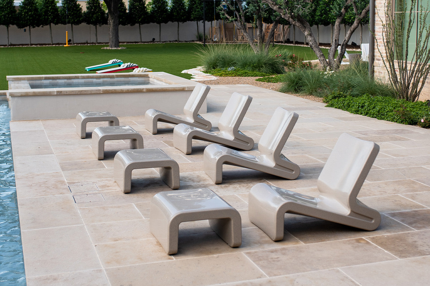 Tupelo Line Chair Sandstone on a patio facing the pool