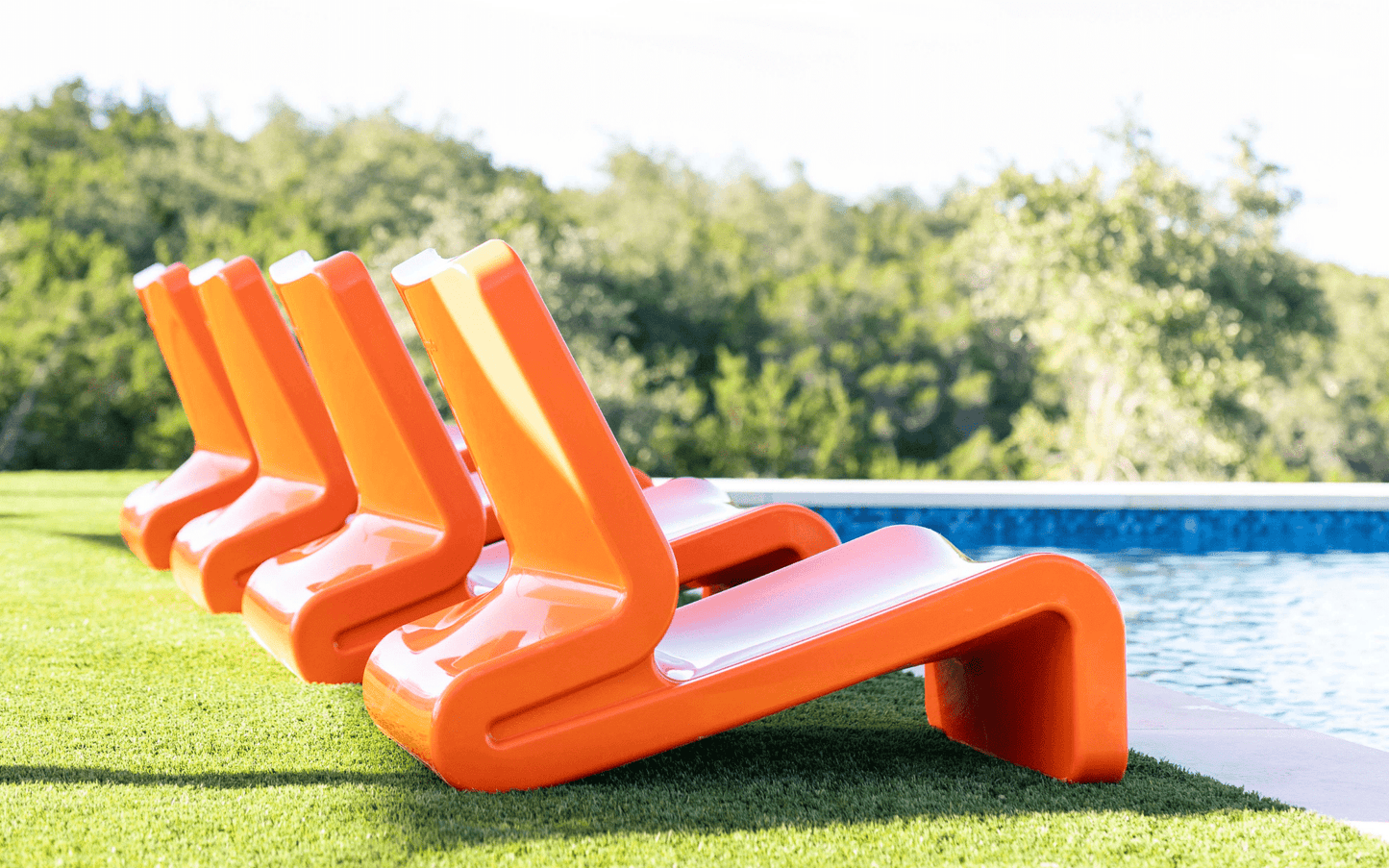 Line Modern In-Pool Lounge Chair - Tupelo Goods - Vintage Orange Bold Modern Lounge Chairs on Artificial Turf
