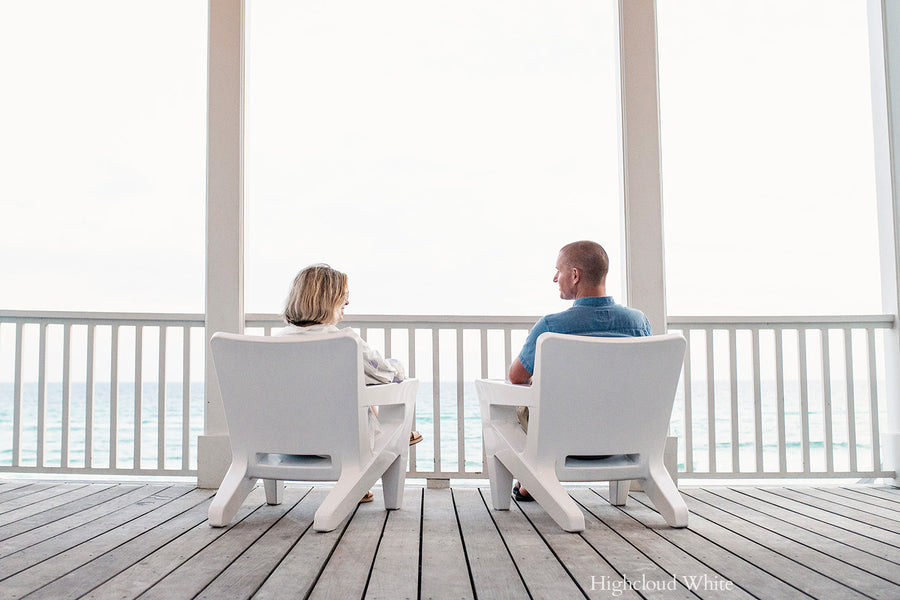 Tupelo Bask Chair Highcloud White on a porch overlooking the ocean