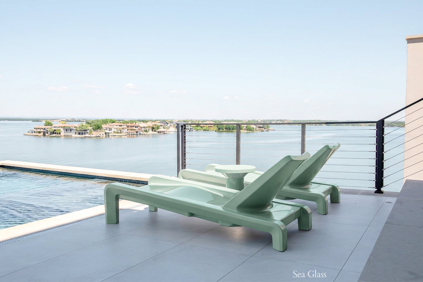 Tupelo Deck Chaise Sea Glass overlooking the lake while sitting poolside