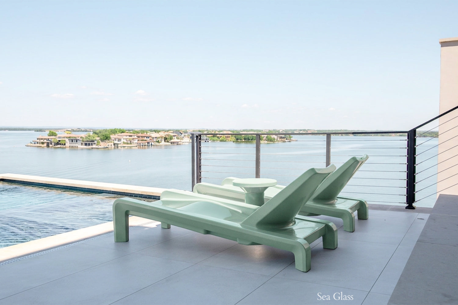 Tupelo Deck Chaise Sea Glass overlooking the lake while sitting poolside