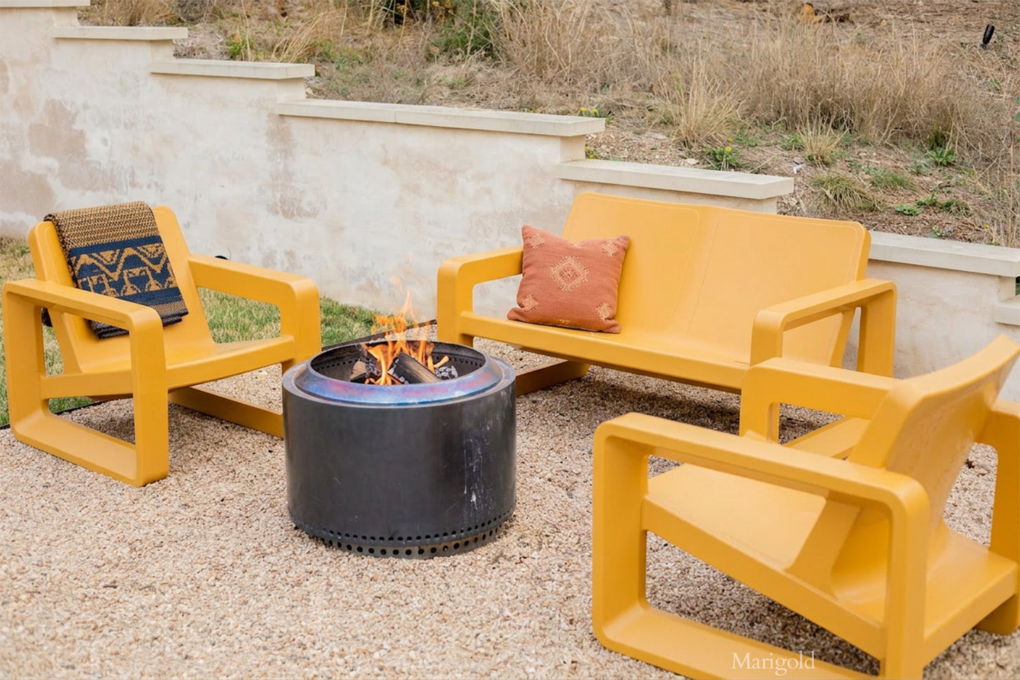 Tupelo Deck Loveseat Marigold and Deck Chair Marigold sitting around a fire pit