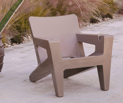 Beige chair on a patio with cacti and a gazebo in the background