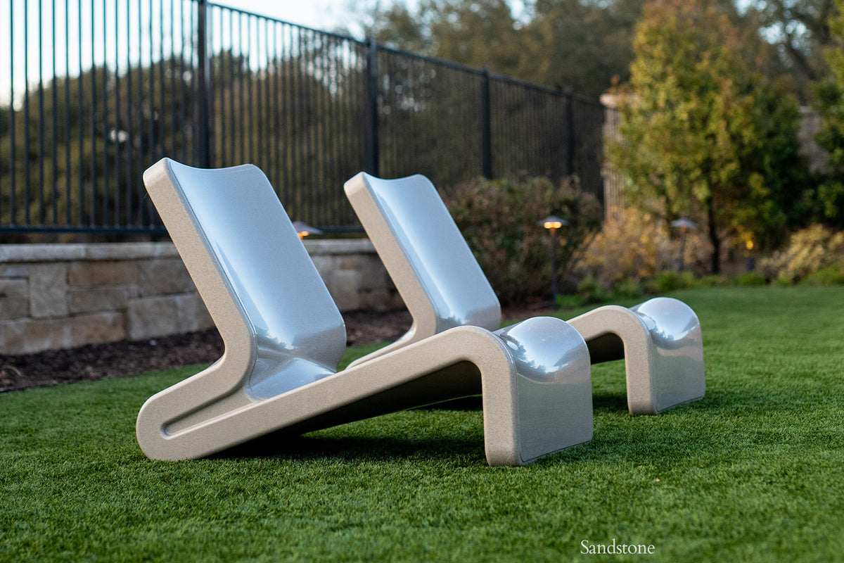 Tupelo Line Chair Sandstone in a backyard