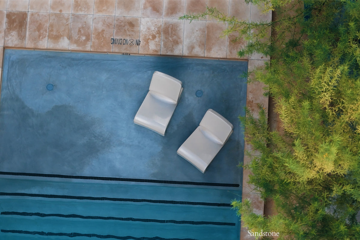 Aerial view of Tupelo Line Chairs Sandstone in a pool