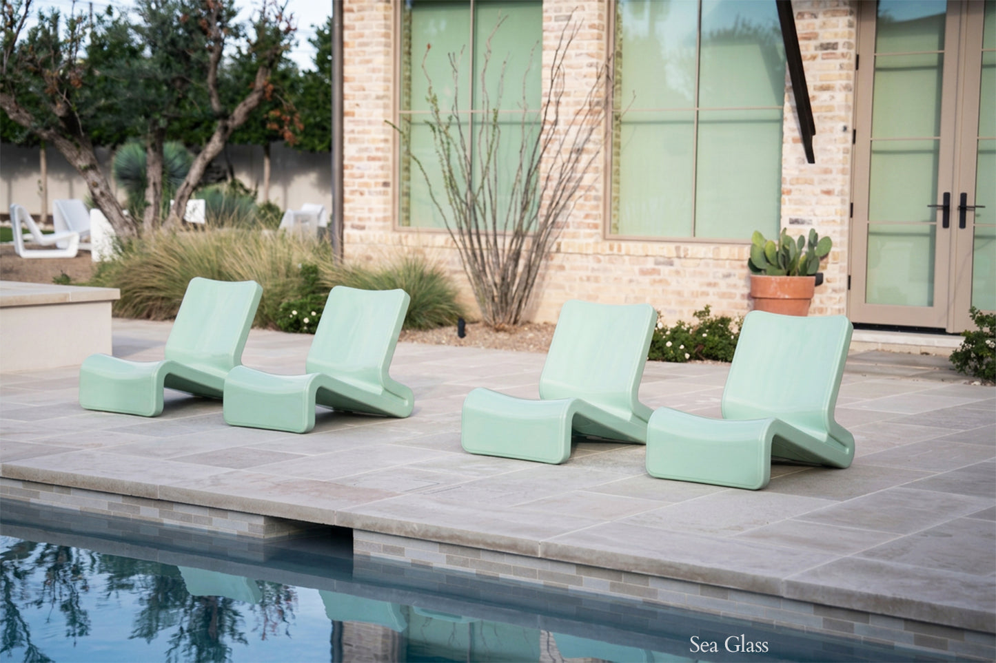 Tupelo Line Chair Sea Glass sitting poolside