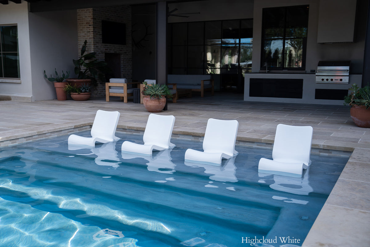 Tupelo Line Chair Highcloud White in a backyard pool
