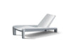 Side image of the waterproof, resin Deck Chaise Lounge in the color Concrete Grey displayed in front of a white background.
