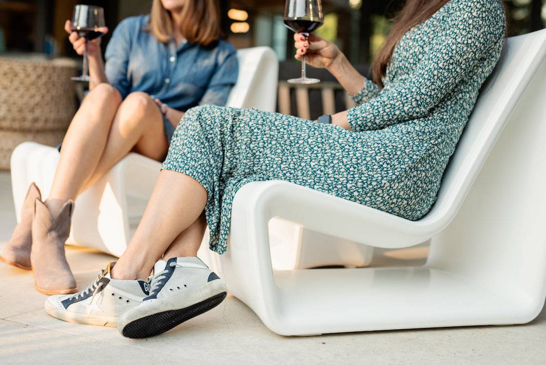 Loop Lounge Chair - Tupelo Goods - Ladies Sitting in a White Outdoor Lounge Chair