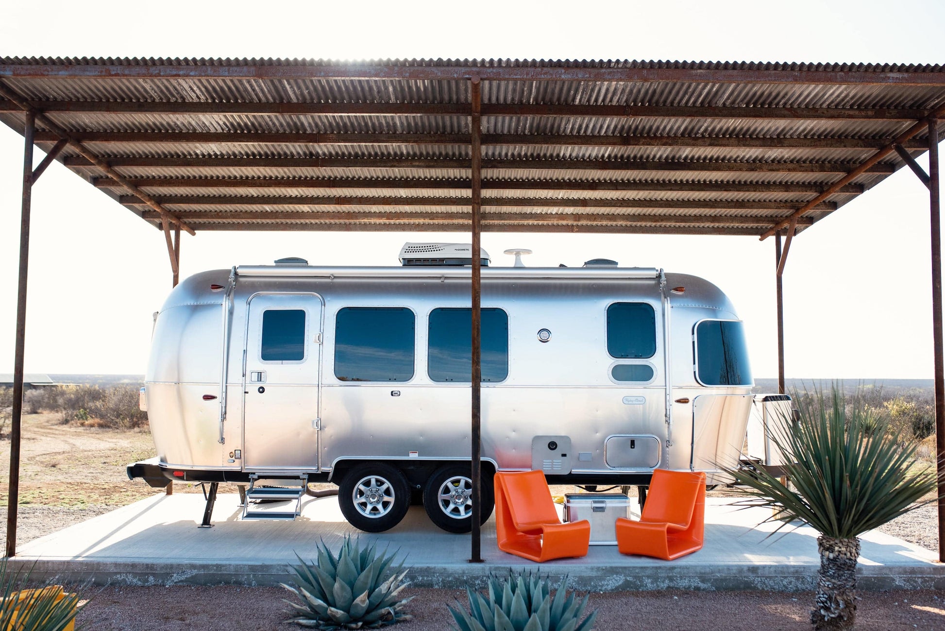 Loop Lounge Chair - Tupelo Goods Vintage Orange in front of Airstream