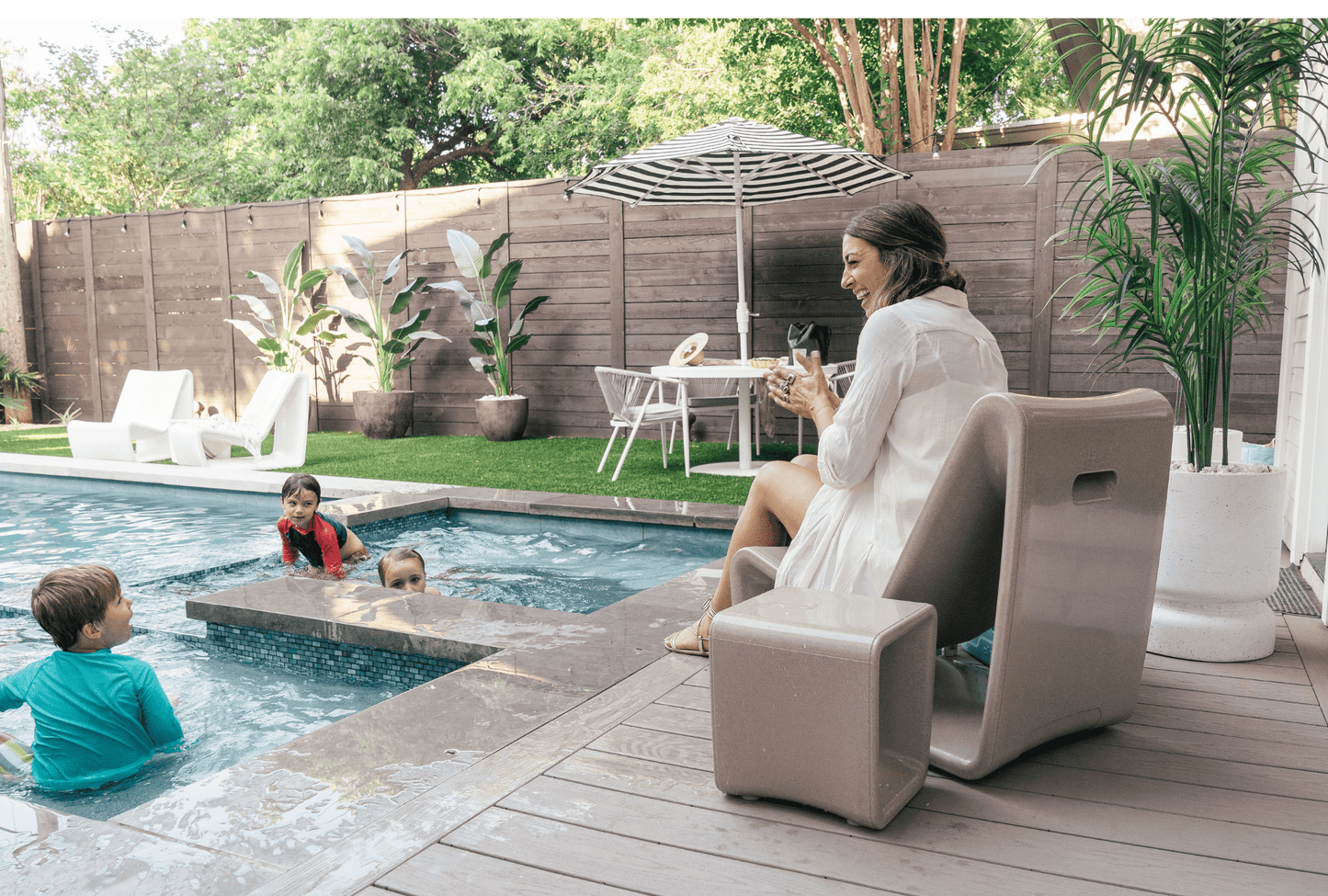 Loop Lounge Chair - Tupelo Goods - Sandstone Woman watching kids in pool