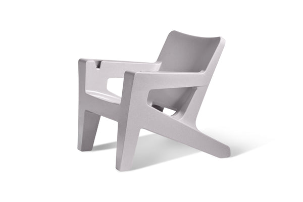Image of an angled view of the Bask Lounge Chair in the color Sandstone, made with resin, displayed on a white background.