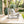 Image of Highcloud White Loop Table in between 2 Highcloud White Loop Lounge Chairs. The all-weathered furniture is outdoors.