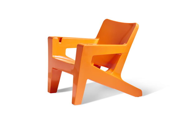 Image of a side view of the Bask Lounge Chair in the color Vintage Orange, made with resin, displayed on a white background.