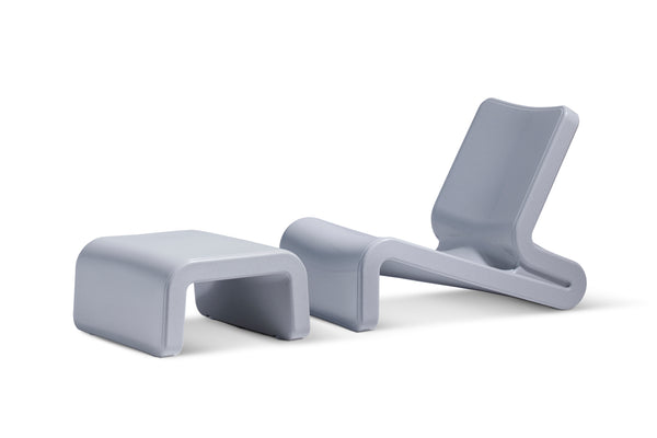 Image of the Concrete Gray Line Lounge chair with the Concrete Gray Ottoman made with resin, in front of a white background.