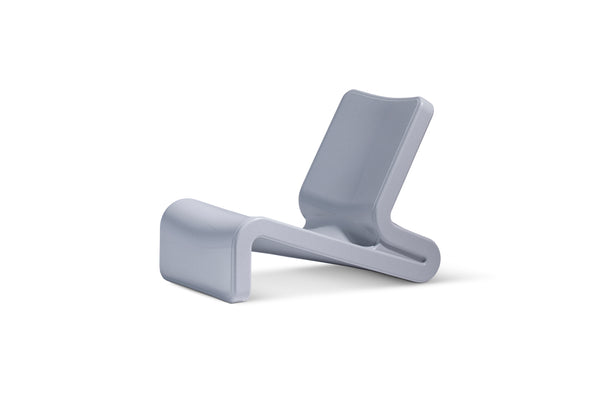 Image shows the modern Line Lounge Chair colour in Concrete Gray made with resin,  displayed in front of a white background.